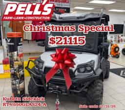 Kubota Sidekick RTVXG850GLAS24-A utility vehicle with factory-installed glass windshield, premium roof, LED light bar, Warn Axon 4500 lb winch, and electric hydraulic bed lift on display at Pells Pells farm service